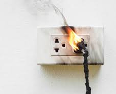 Electrical outlet on a white wall with flames and smoke coming from a plugged-in cord. Emergency Electrical Services