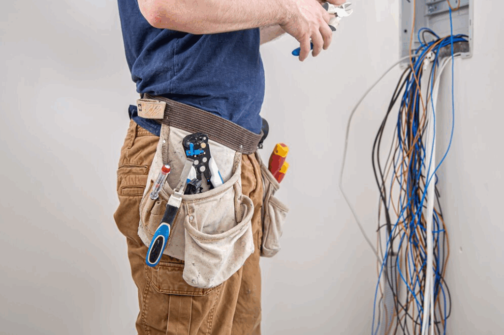 Electrician's tool belt and exposed wiring. Electrical Wiring & Rewiring