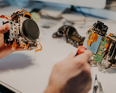 Technician repairing electronic circuitry.